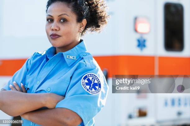 paramédico hembra frente a la ambulancia - emergency services fotografías e imágenes de stock