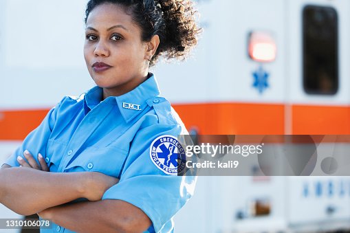 Female paramedic in front of ambulance Female paramedic in front of ambulance