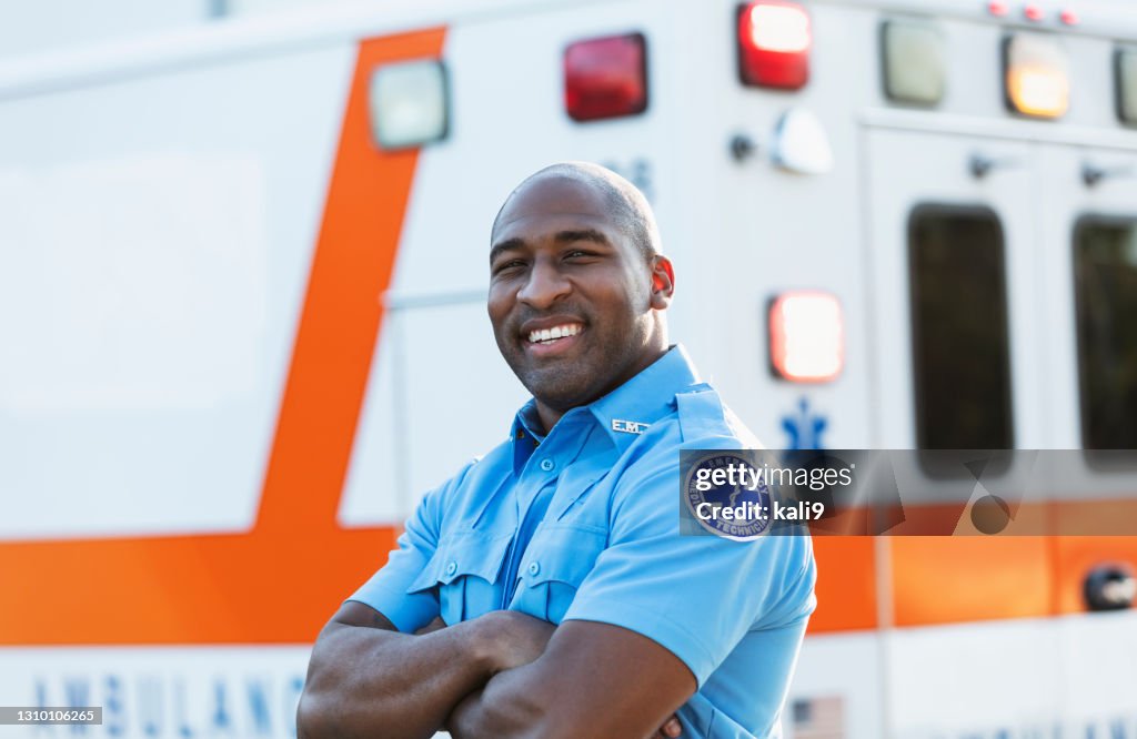 Paramedic in front of ambulance