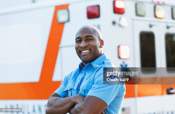 paramedic in front of ambulance - paramedic stock pictures, royalty-free photos & images