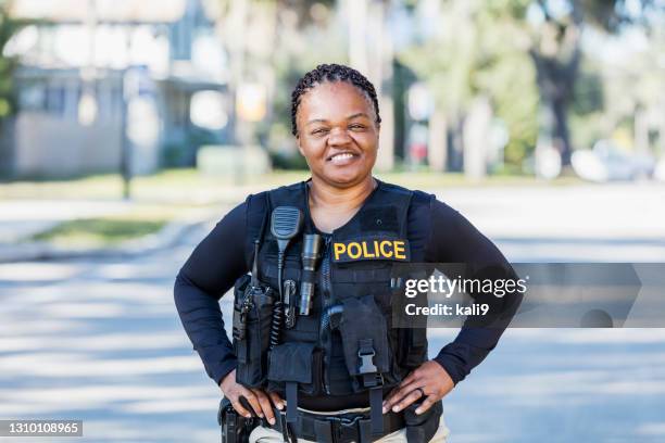 african-american policewoman on foot patrol - police officer smiling stock pictures, royalty-free photos & images