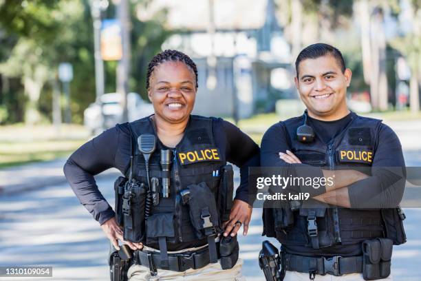 two police officers on foot patrol - police officer smiling stock pictures, royalty-free photos & images