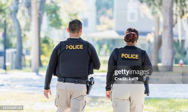 dos policías caminando en comunidad - police fotografías e imágenes de stock