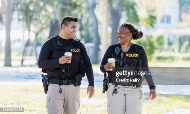 two police officers walking in community - female with friend in coffee stock pictures, royalty-free photos & images