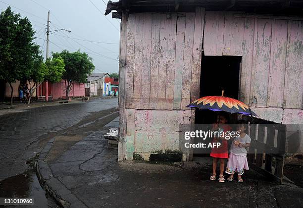 Two girls stand in the street in Acahualinca neighborhood, in the banks of Xolotlan lake in Managua on October 31, 2011. Nicaraguan authorities...