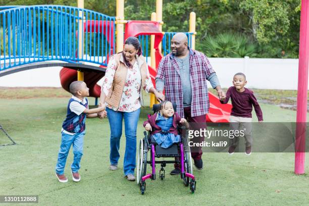 family walk at playground, girl in wheelchair, twin boys - special needs children stock pictures, royalty-free photos & images