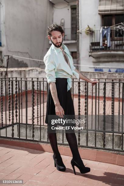 pensive non binary person. thoughtful transgender person with beard wearing woman clothes - white skirt stock pictures, royalty-free photos & images