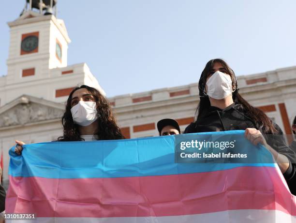 Activists hold a trans flag during a rally on International Transgender Day of Visibility on March 31, 2021 at Plaza del Sol in Madrid, Spain....