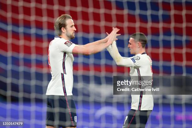 Harry Kane of England celebrates with Phil Foden after scoring their side's first goal from the penalty spot during the FIFA World Cup 2022 Qatar...