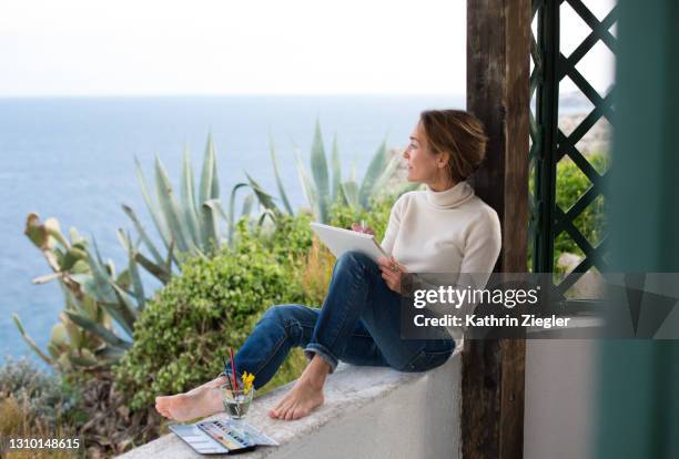 woman drawing on a terrace overlooking the sea - women's water polo bildbanksfoton och bilder