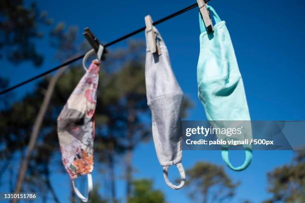 low angle view of clothes hanging on clothesline against sky,uruguay - tapabocas stock pictures, royalty-free photos & images