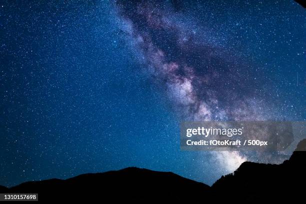 low angle view of silhouette of mountain against star field at night,austria - milky way stock pictures, royalty-free photos & images