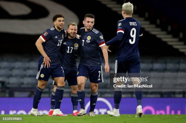 Che Adams of Scotland celebrates with teammates John McGinn, Ryan Fraser and Lyndon Dykes after scoring their team's third goal during the FIFA World...