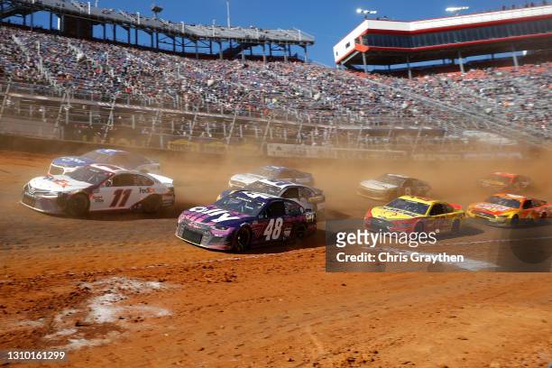 Denny Hamlin, driver of the FedEx Freight Toyota, leads a pack of cars during the NASCAR Cup Series Food City Dirt Race at Bristol Motor Speedway on...
