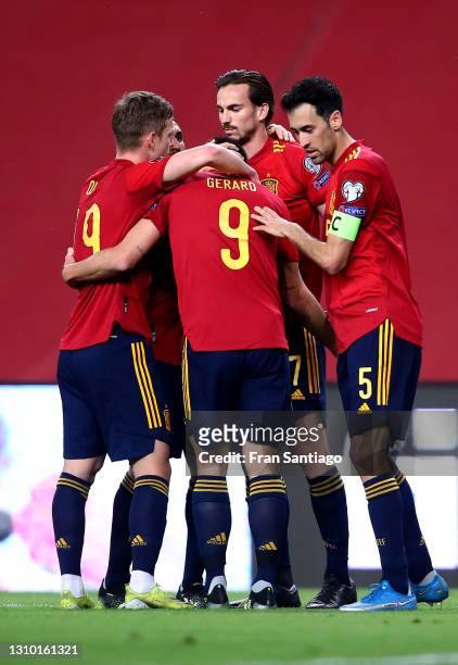 Gerard Moreno of Spain celebrates with teammates Sergio Busquets and Dani Olmo after scoring their team's third goal during the FIFA World Cup 2022...