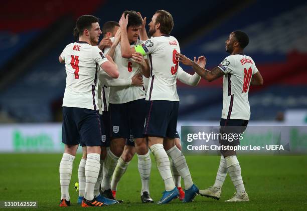 Harry Maguire of England celebrates with Declan Rice, Harry Kane and Raheem Sterling after scoring their side's second goal during the FIFA World Cup...