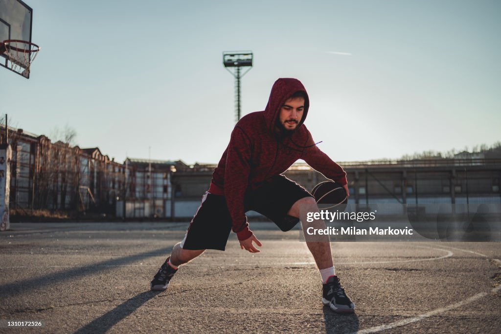 Young man on a basketball court. With hard training to success, a promising basketball player.