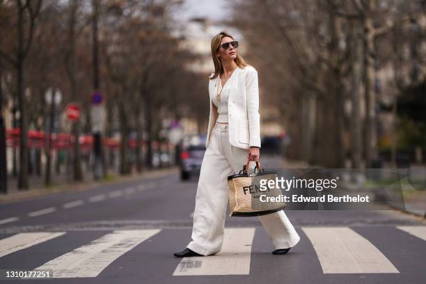 Natalia Verza @mascarada.paris wears a Fendi total look, Fendi monogram sunglasses, a golden chain necklace, a cropped v-neck wool pullover from...