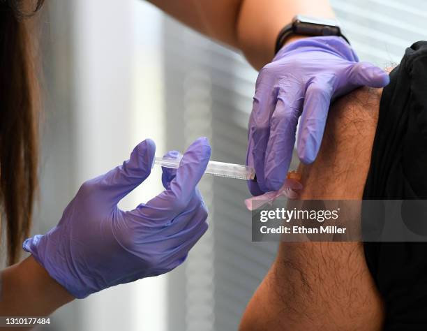 Concentra registered nurse Sofia Mercado administers a Moderna COVID-19 vaccination to an Amazon employee at an Amazon fulfillment center on March...