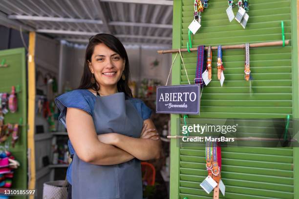 kleine ladenbesitzerin mit "offenem" geschäftseröffnungskonzept-zeichen - mexikanischer abstammung stock-fotos und bilder