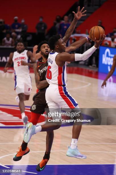 Hamidou Diallo of the Detroit Pistons drives to the basket past Derrick Jones Jr. #5 of the Portland Trail Blazers during the second half at Little...