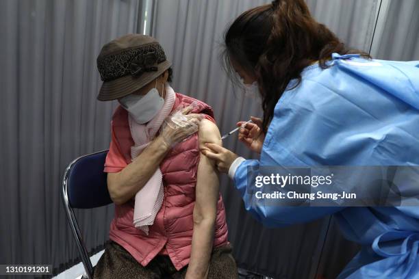 South Korean elderly woman receives the first dose of the Pfizer-BioNTech Covid-19 coronavirus vaccine at a vaccination centre on April 01, 2021 in...