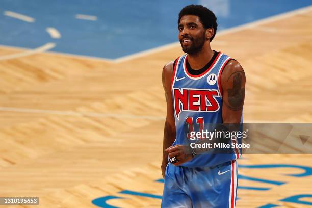 Kyrie Irving of the Brooklyn Nets smiles following their 120-108 win over the Houston Rockets at Barclays Center on March 31, 2021 in New York...