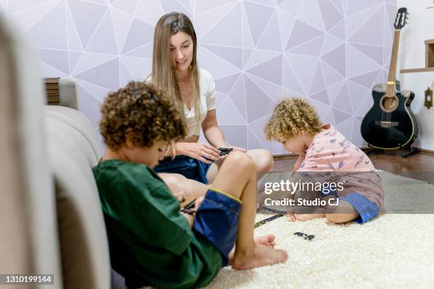 children learning to play with the game of dominoes - custody stock pictures, royalty-free photos & images