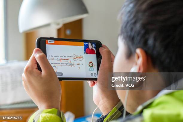 Child uses the mobile app of Yuanfudao, a Beijing-based online education startup, on a smartphone on March 31, 2021 in Shanghai, China.