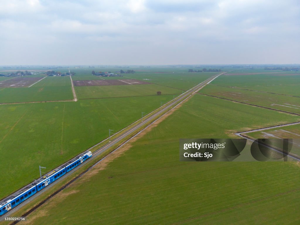 Train of Keolis and Overijssel province driving on the Kamperlijntje in a rural landscape