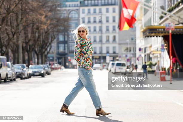 Best Ager Model and Influencer Petra van Bremen wearing sunglasses by Linda Farrow, brown and beige python cowboy boots by Tony Mora, a multicolored...