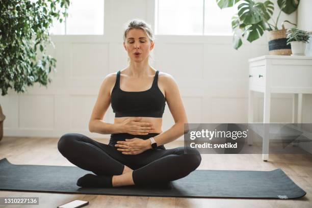 yoga at home - breathing exercise stock pictures, royalty-free photos & images