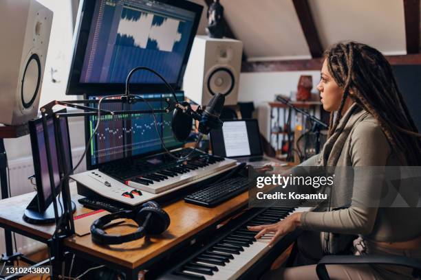 dedicated young woman, an audio engeener, working on sound mixing from her music and sound record studio - record producers stock pictures, royalty-free photos & images