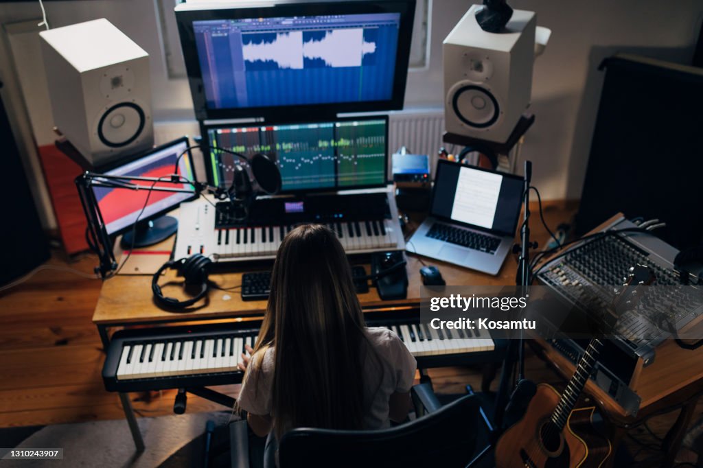 Female Modern Music Producer Working From Her Well Equipped Music Studio  While Digital Recording Chords She Play On The Electric Keyboard High-Res  Stock Photo - Getty Images