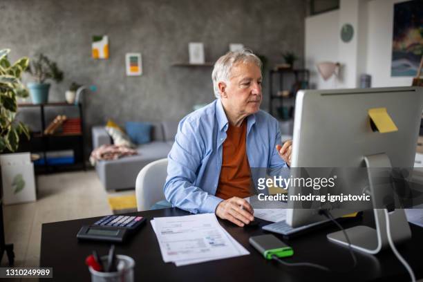 senior man concentrated on his work - old pc stock pictures, royalty-free photos & images