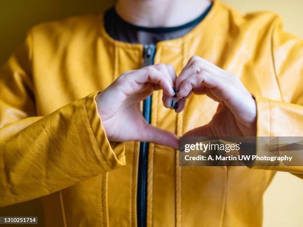 woman making hands in heart shape, heart health insurance, social responsibility, donation charity, world heart day, appreciation concept, world mental health day - gratitude stockfoto's en -beelden