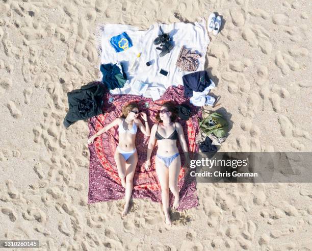 An aerial drone view of Karla and Jemima sunbathing at Bournemouth Beach on March 30,2021 in Bournemouth, England. Weather is expected to become...