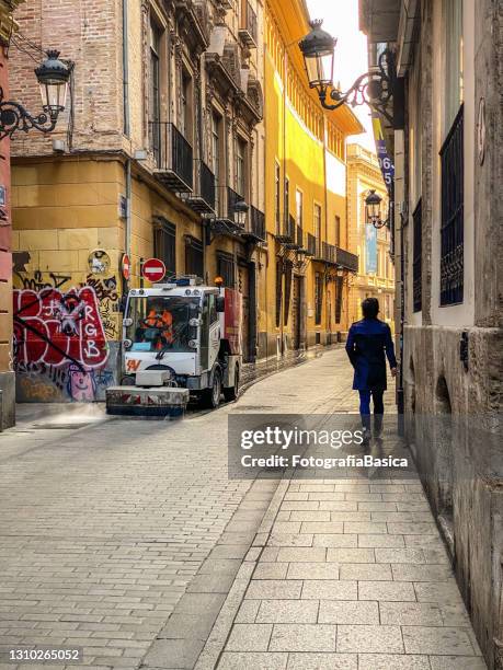 cleaning the street in old town valencia, spain - cleaning graffiti stock pictures, royalty-free photos & images