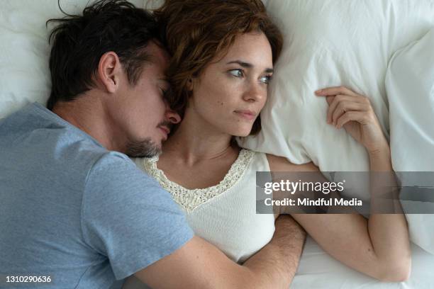 close-up of couple lying on bed at home - couple relationship problem stock pictures, royalty-free photos & images