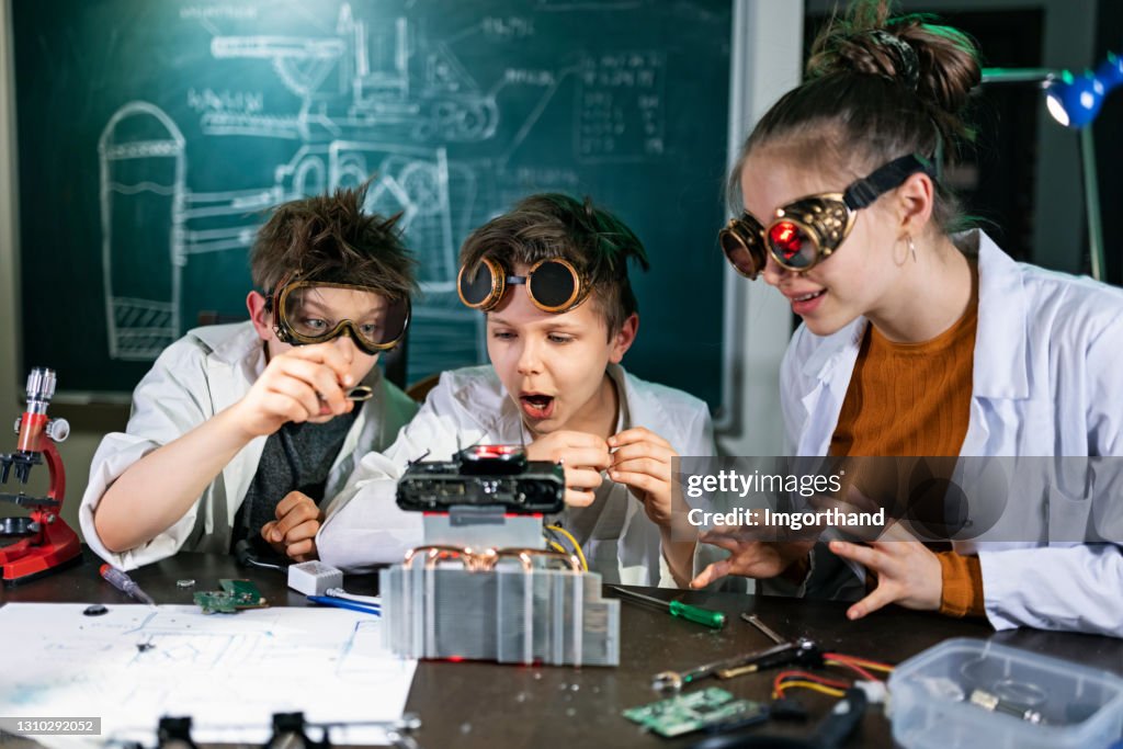 Three young inventors are building a mysterious device