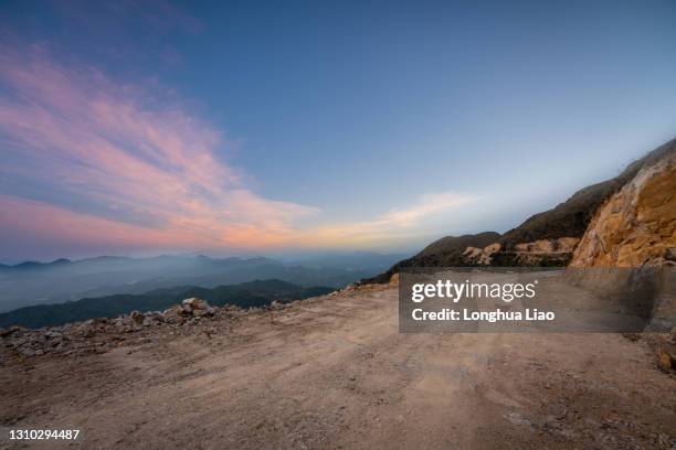 a dirt road at dusk on the top of a hill - dirt road landscape sunset stock pictures, royalty-free photos & images