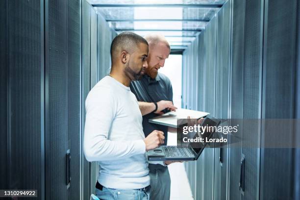 a male duo of server room technicians at business reopening - server professional stock pictures, royalty-free photos & images