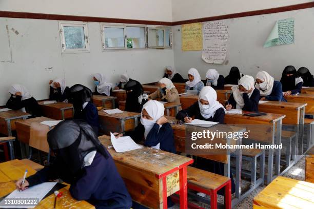 Schoolgirls wearing a facemask as a preventive measure against the spread of the Covid-19 coronavirus, listen to ​a lesson at a school on April 01,...