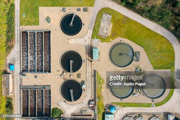 drone view of a sewage treatment plant - water plant stock pictures, royalty-free photos & images