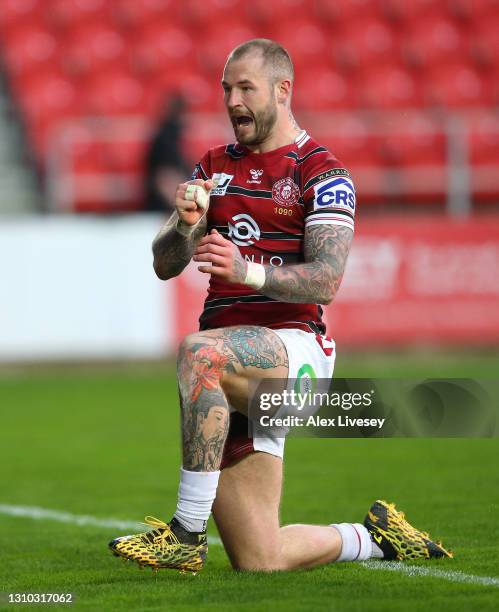 Zak Hardaker of Wigan Warriors celebrates after scoring their third try during the Betfred Super League match between Wigan Warriors and Wakefield...