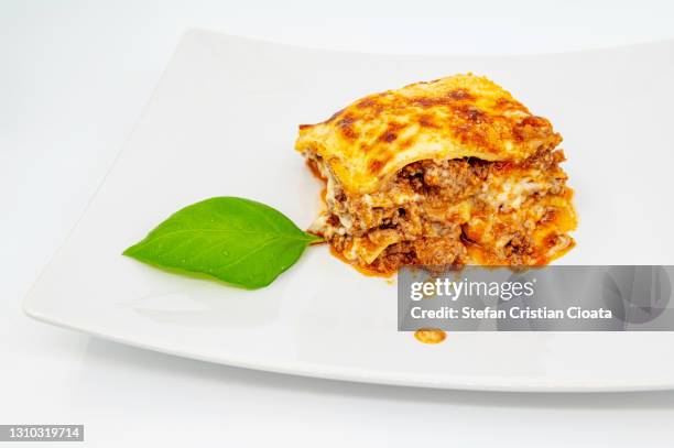 ragu lasagna on white plate - serving lasagna stock pictures, royalty-free photos & images
