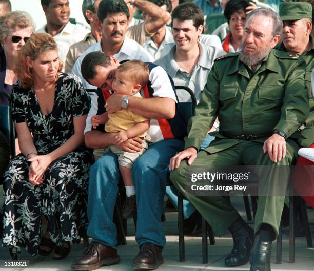 Cuban president Fidel Castro, right, sits with Juan Miguel Gonzalez, his wife Nelsey Carmini, and son during a visit to the Marcelo Salado school to...