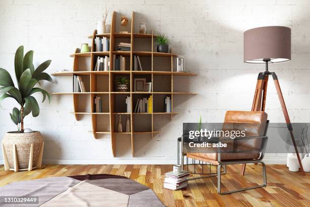 diseño creativo de estanterías con sillón - libreria fotografías e imágenes de stock