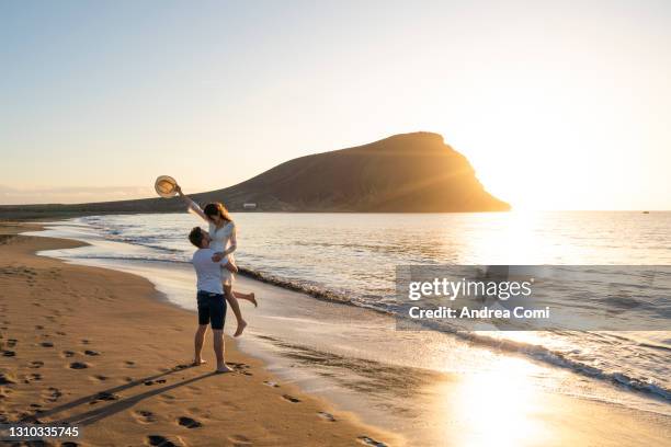 young couple having fun at beach la tejita, tenerife, canary islands - atlantic islands stock-fotos und bilder