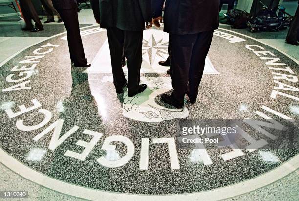 President George W. Bush, Central Intelligence Agency Director George Tenet and others stand on the seal of the Agency March 20, 2001 at the CIA...